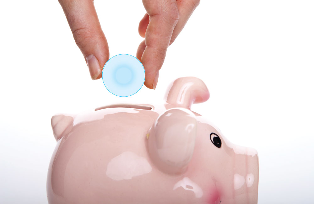 hand placing cheap contact lens into a piggy bank